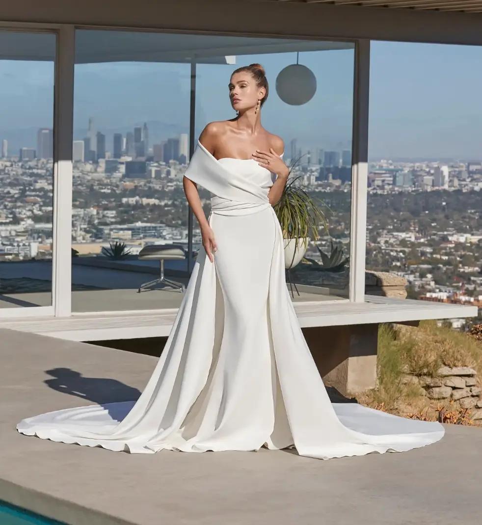 Model wearing a white gown by Casablanca Bridal