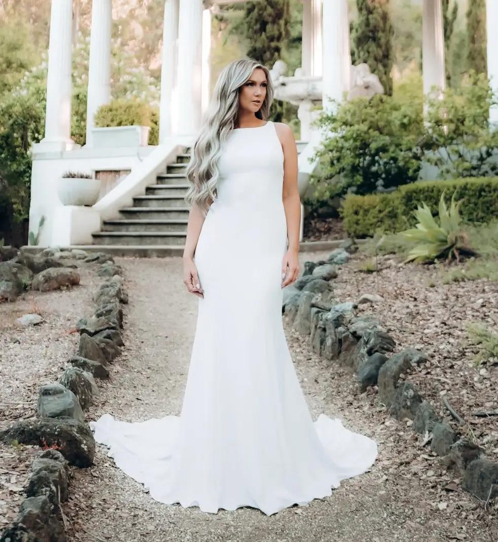 Model wearing a white gown by Stella York