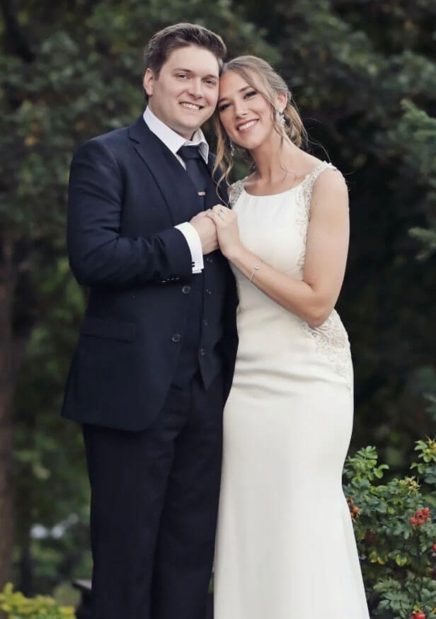 Сouple wearing a milk gown and a black suit