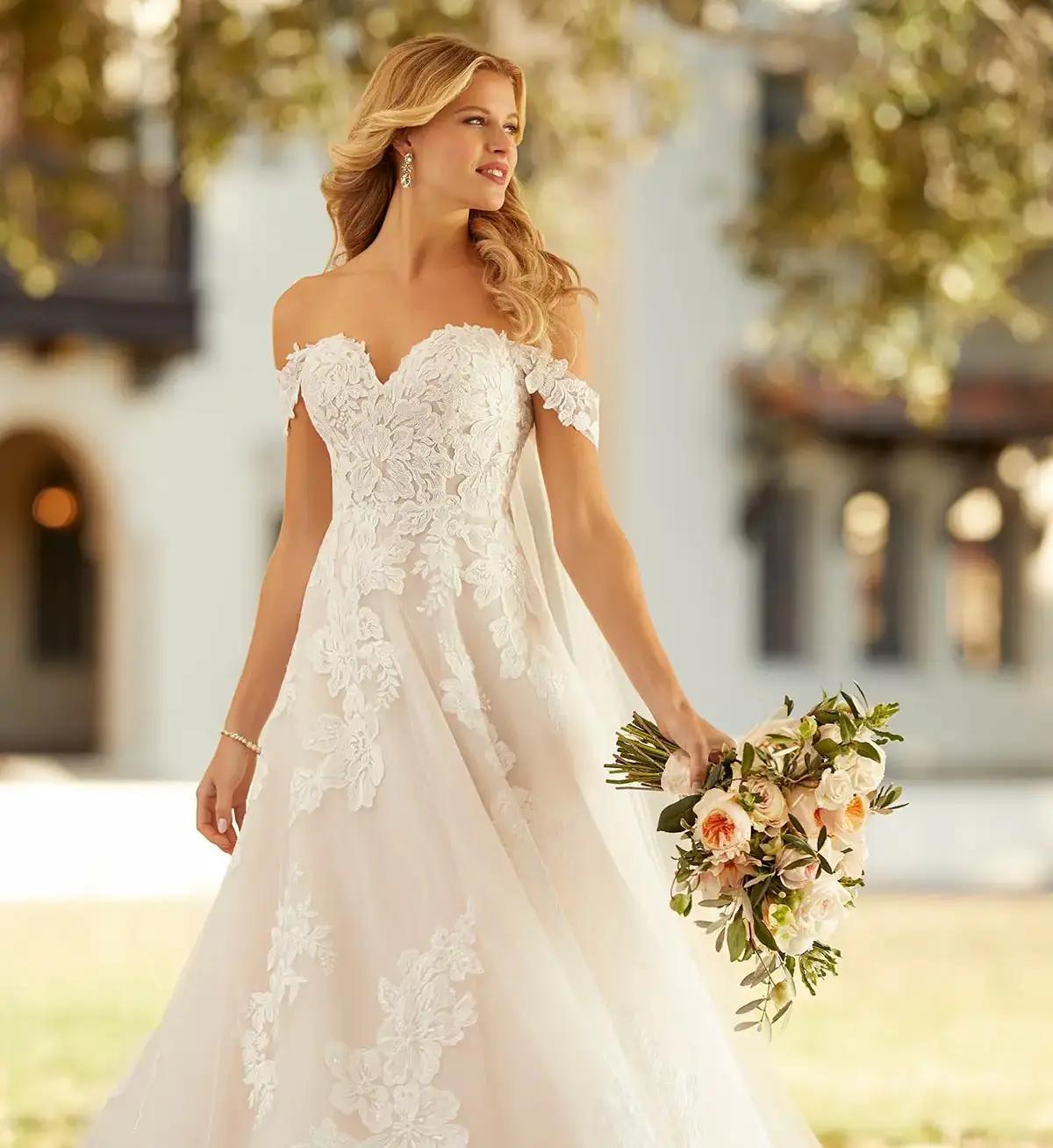 Model wearing a white gown by Casablanca Bridal