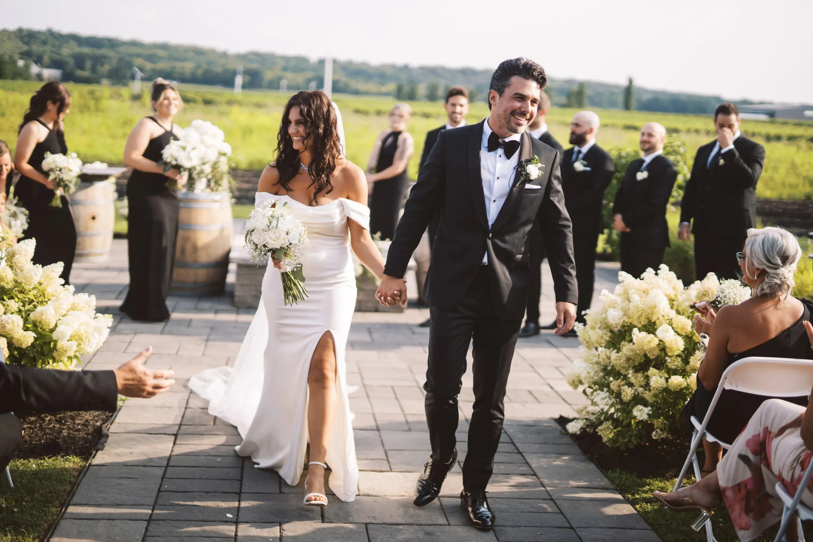 Сouple wearing a white gown and a black suit