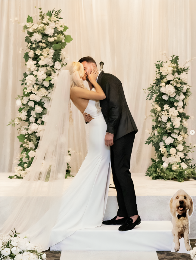 Сouple wearing a white gown and a black suit